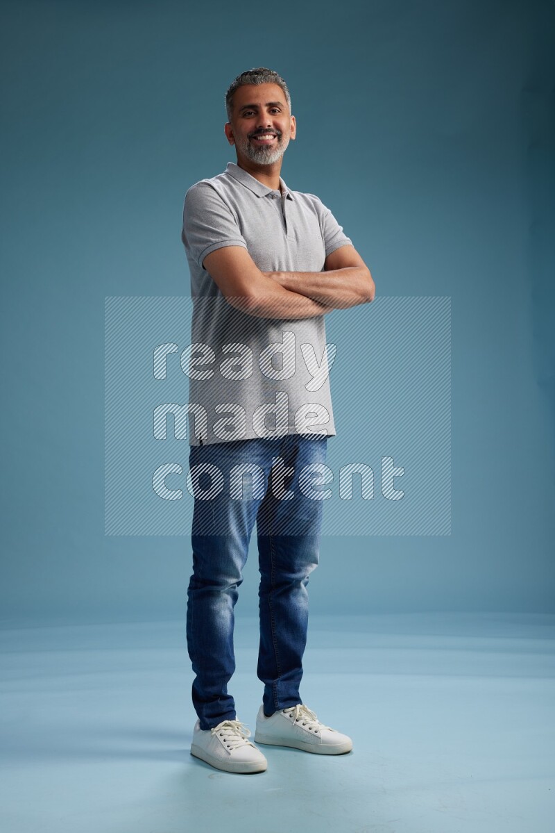 Man Standing Interacting with the camera on blue background