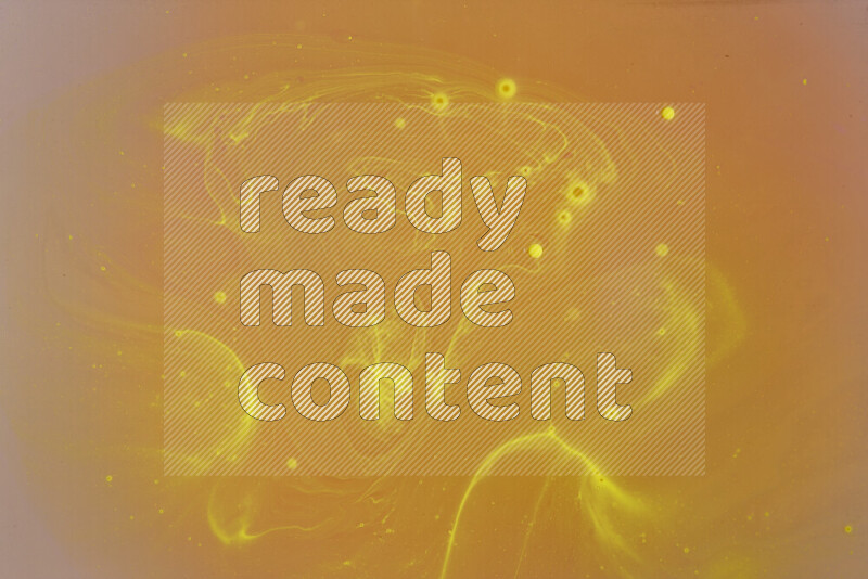 The image captures a dramatic splatter of yellow paint over a white backdrop