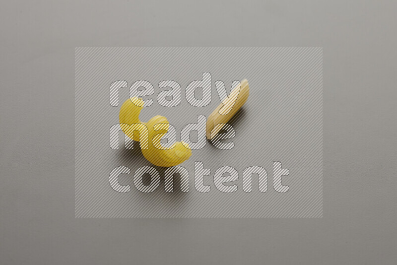 Twist pasta with other types of pasta on grey background