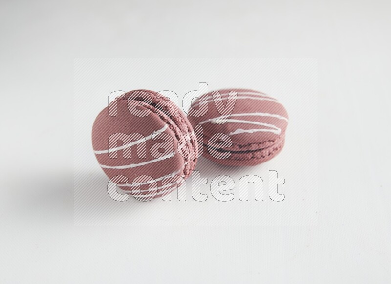 45º Shot of two Red Poppy Flower macarons on white background