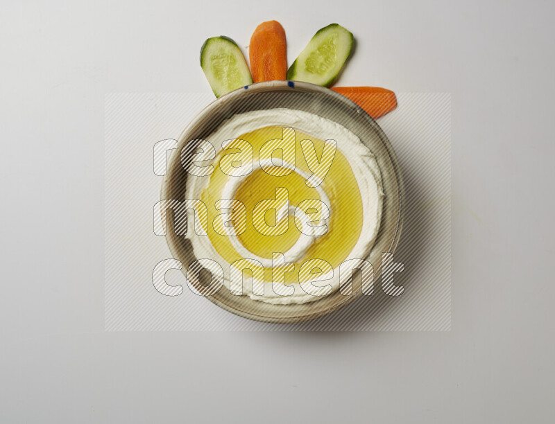 Lebnah garnished with olive oil in a grey pottery plate on a white background