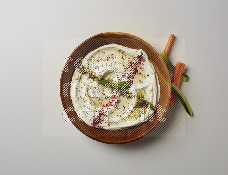 Lebnah garnished with  zattar , sumak & mint in a wooden plate on a white background