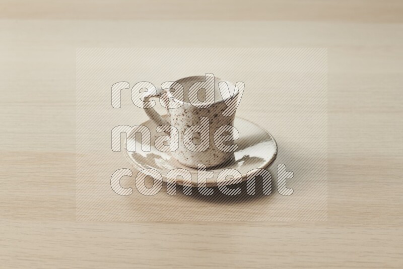A pottery cup on light wooden background