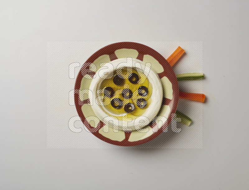 Lebnah garnished with sliced olives in a traditional plate on a white background