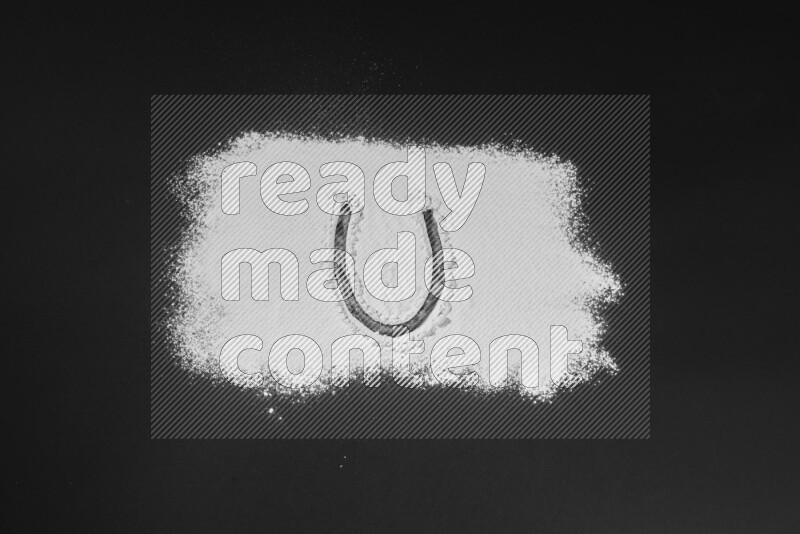 Alphabets written with powder on black background