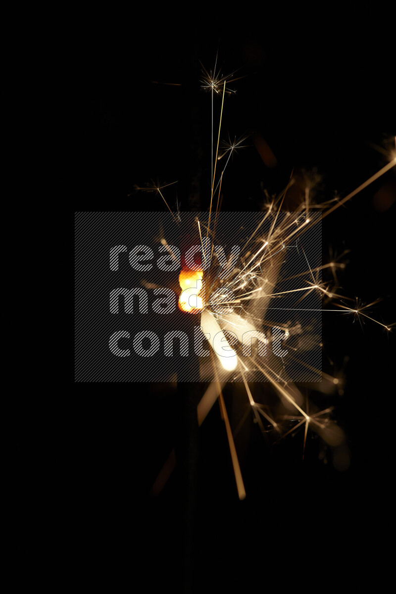 A close-up image of sparkler candle isolated on black background
