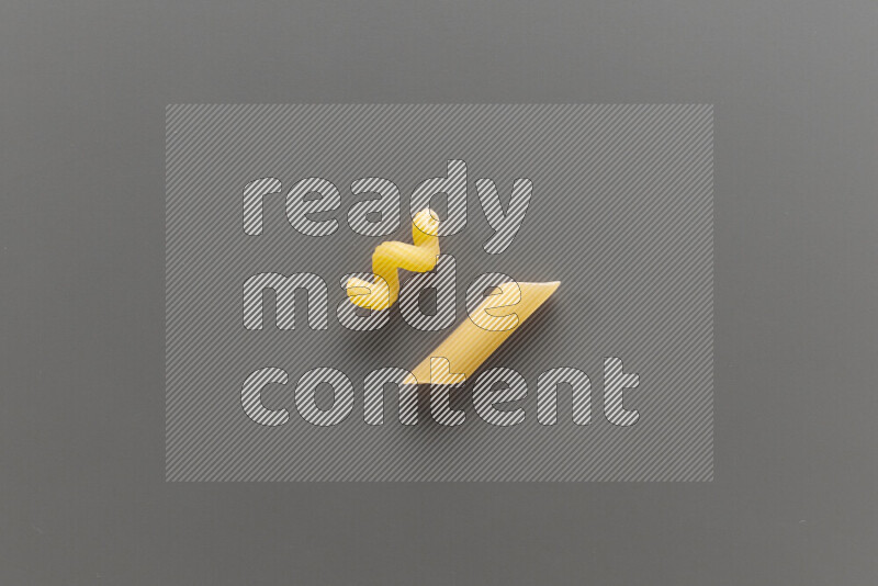 Twist pasta with other types of pasta on grey background