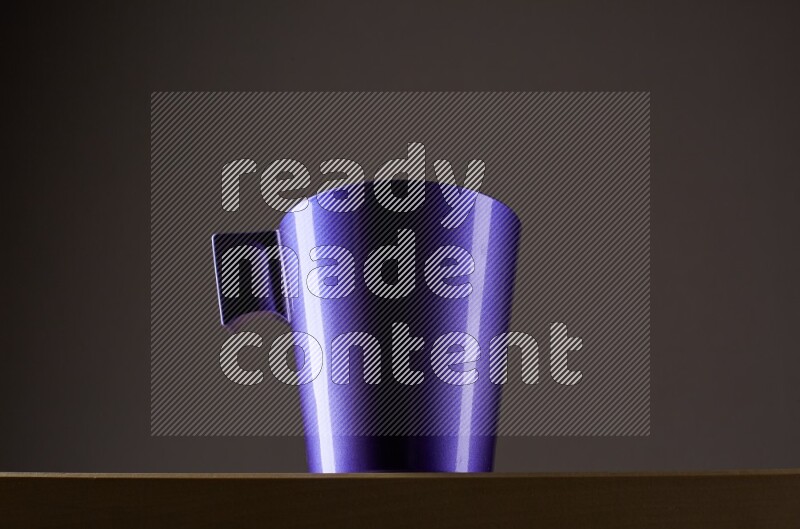 Low angle shot of a purple cup on grey background