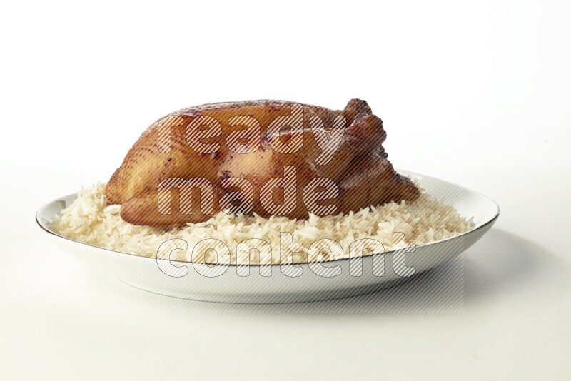white  basmati Rice with  whole roasted chicken  on a white plate with a silver rim direct  on white background