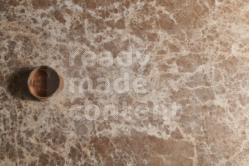 A pottery cup on beige marble background