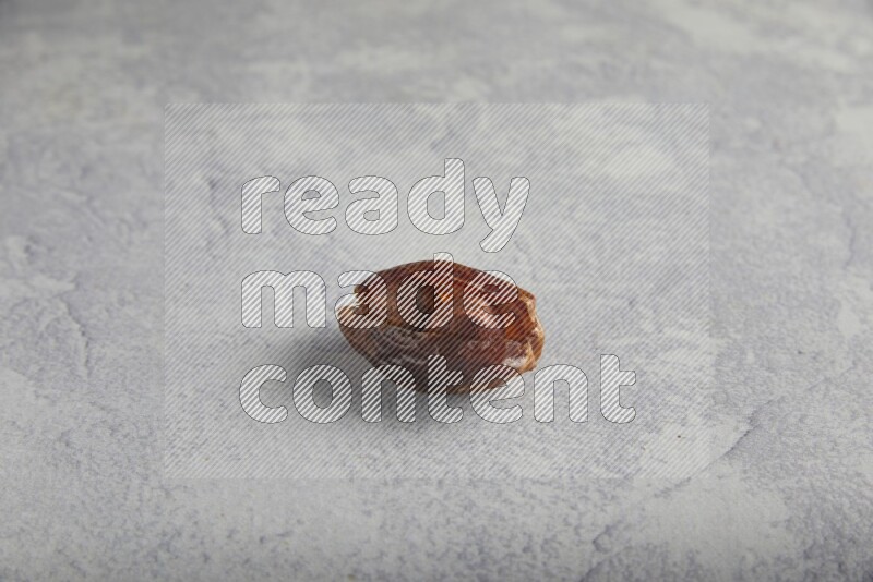 Hazulnut stuffed date on light grey background