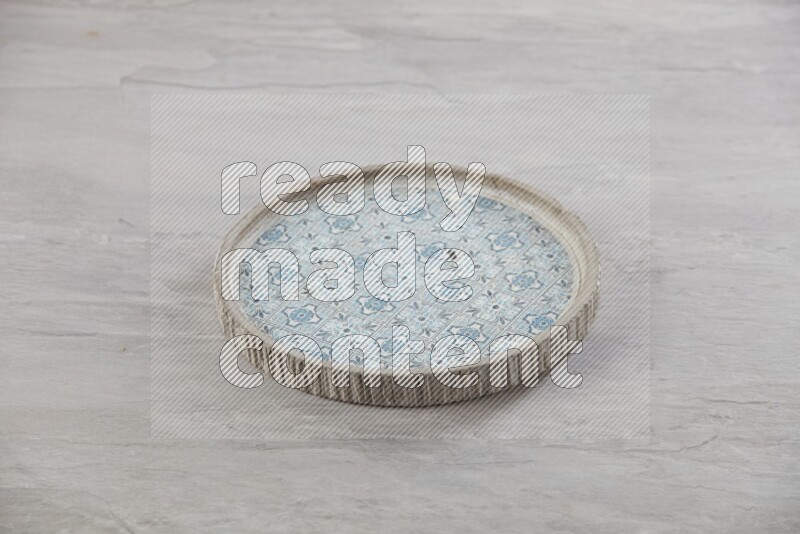 multi color ceramic round plate on grey textured countertop