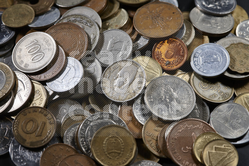 A close-ups of random old coins on black background