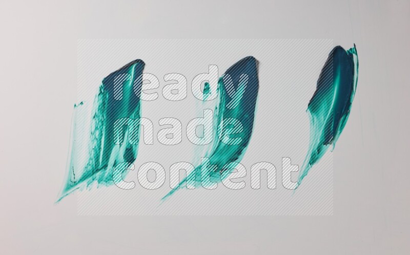 Turquoise painting knife strokes on white background