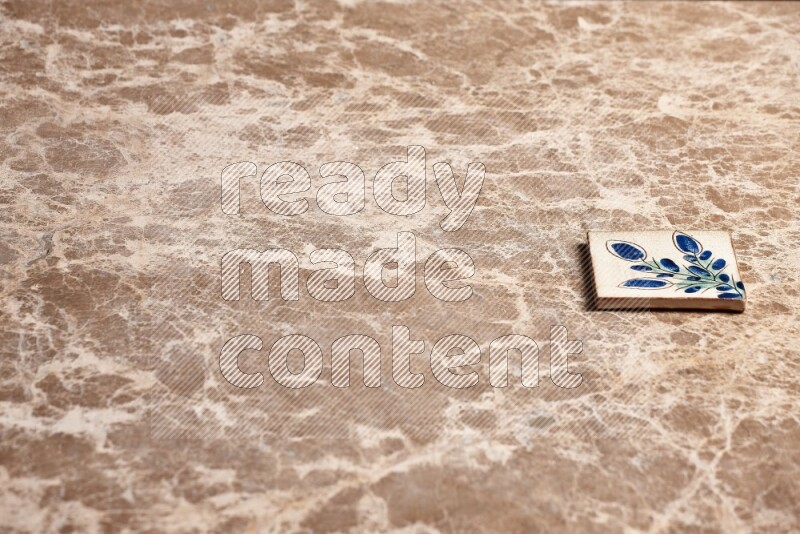 A decorative coaster on beige marble background