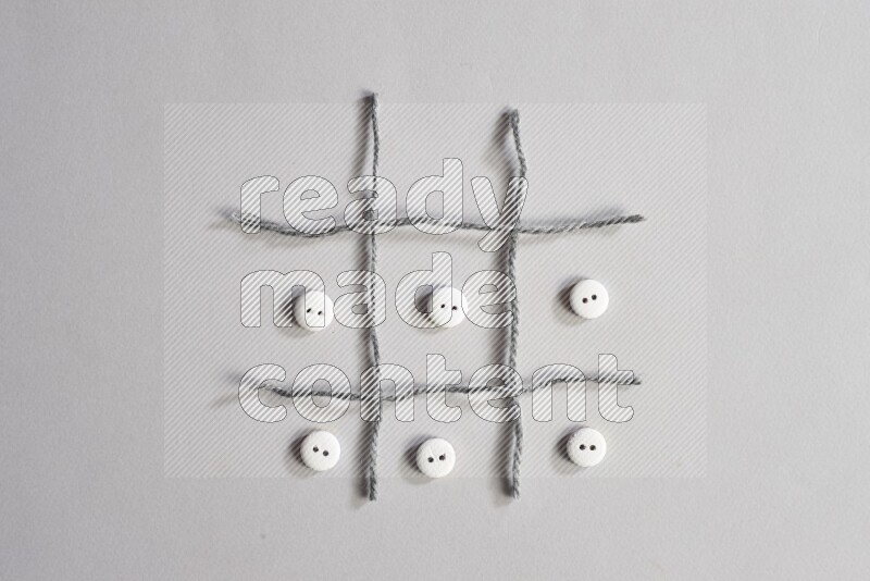 White buttons placed on grey background