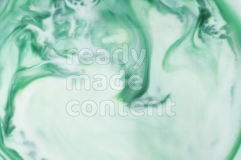 A close-up of abstract swirling patterns in green gradients