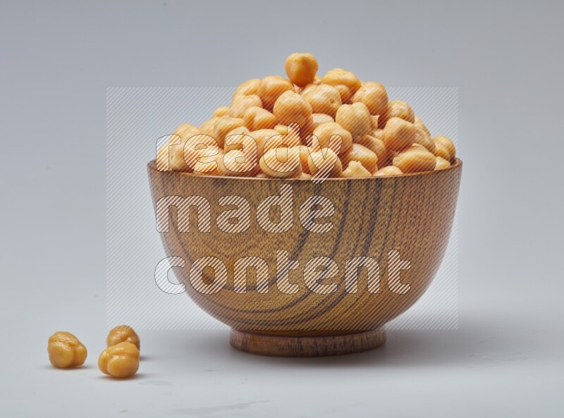 Close up shot of boiled chickpeas in a container on white background