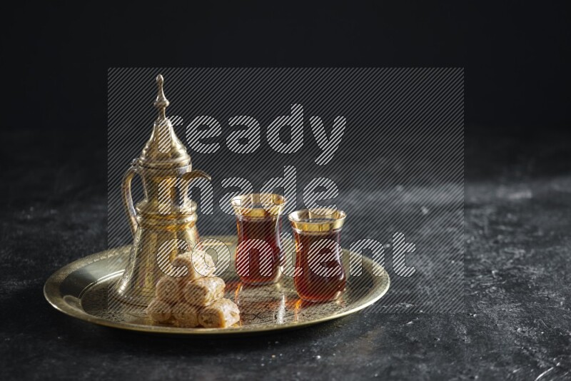 Golash with a drink on a metal tray in a dark setup