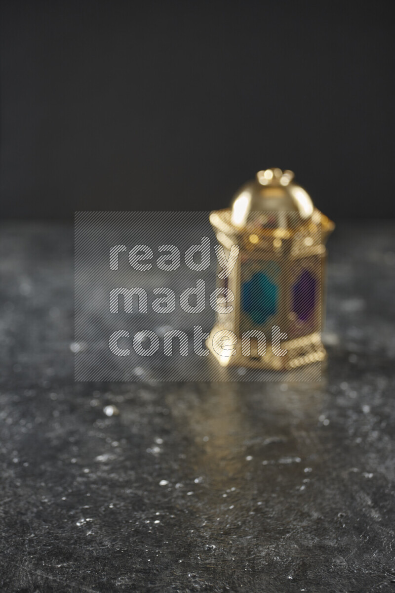 A lantern placed on a textured black background