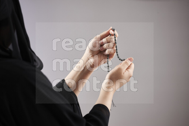 Woman hands holding praying beads (sebha) in different positions