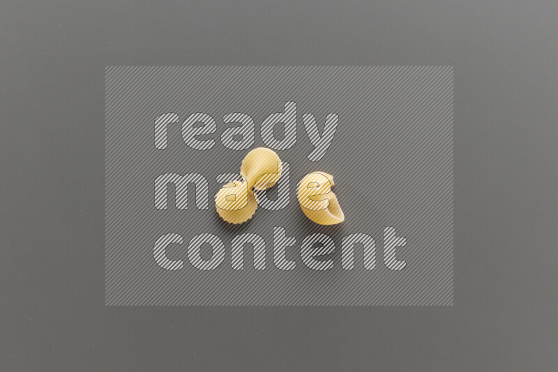 Fiocchi pasta with other types of pasta on grey background