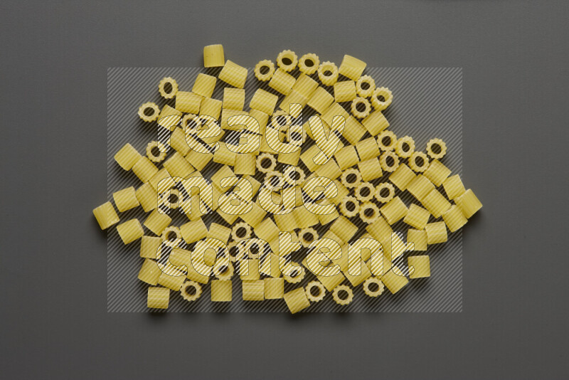 Small rings pasta on grey background
