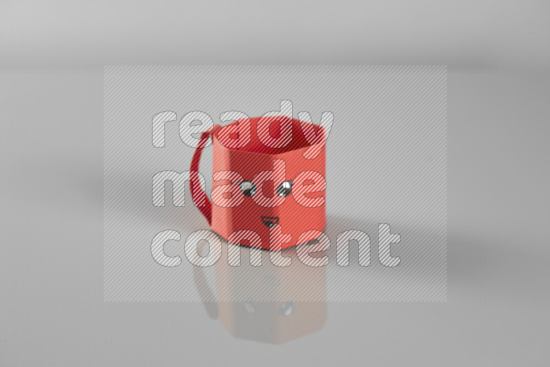 Origami cup on grey background
