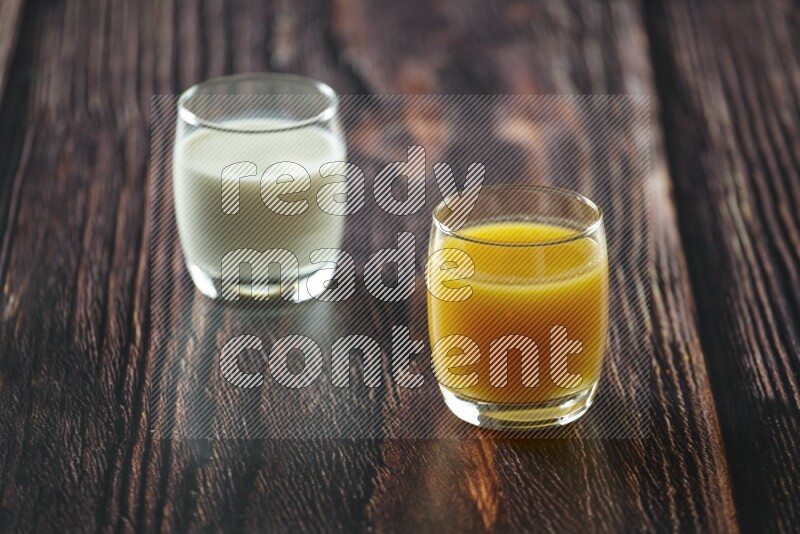 Cold drinks in a glass cup such as water, tamarind, qamar eldin, sobia, milk and hibiscus on wooden background