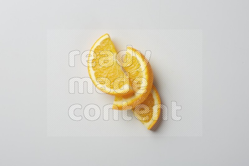 Three halves of an orange slices on white background