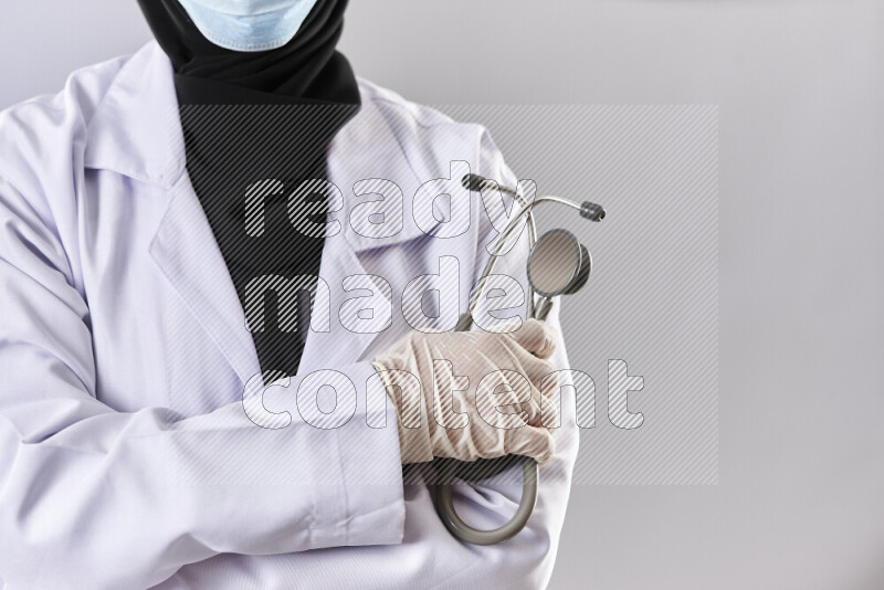 Female doctor wearing an abaya and medical attire in different positions
