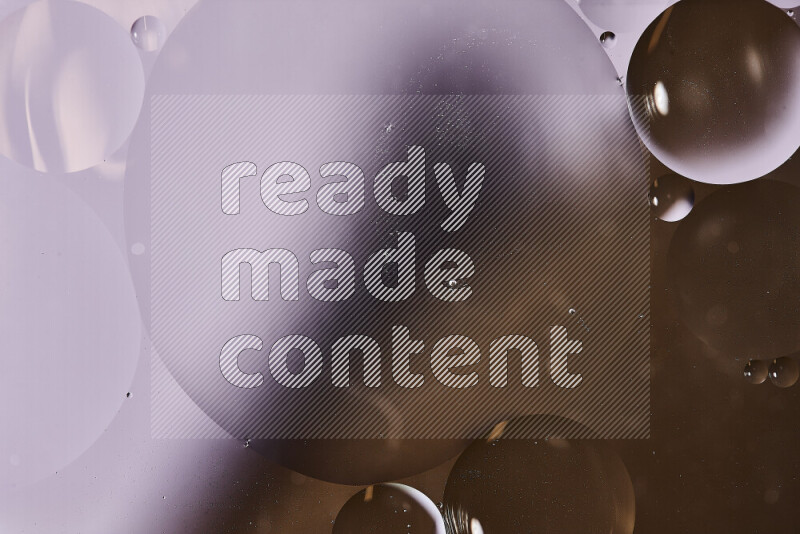 Close-ups of abstract oil bubbles on water surface in shades of white and brown