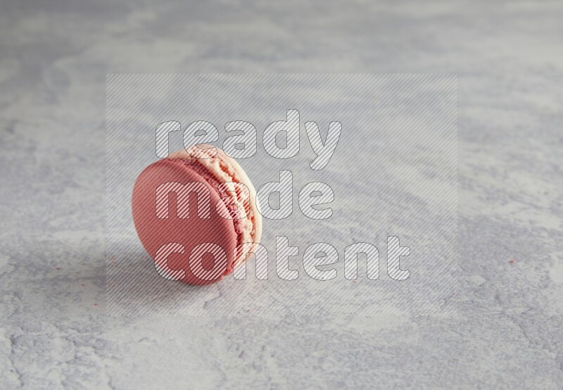 45º Shot of Pink Litchi Raspberry macaron on white  marble background