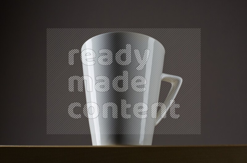 Low angle shot of a white cup on grey background