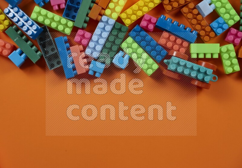 Multicolored plastic building blocks on different backgrounds (kids toys)