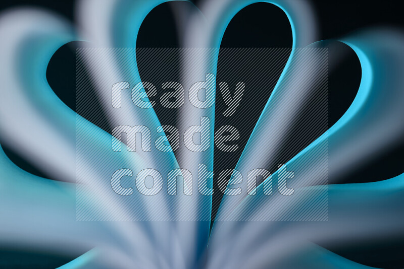 An abstract art piece displaying smooth curves in white and blue gradients created by colored light