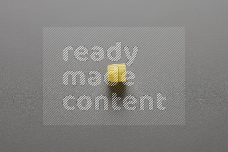 Small rings pasta on grey background