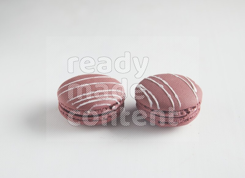 45º Shot of two Red Poppy Flower macarons on white background