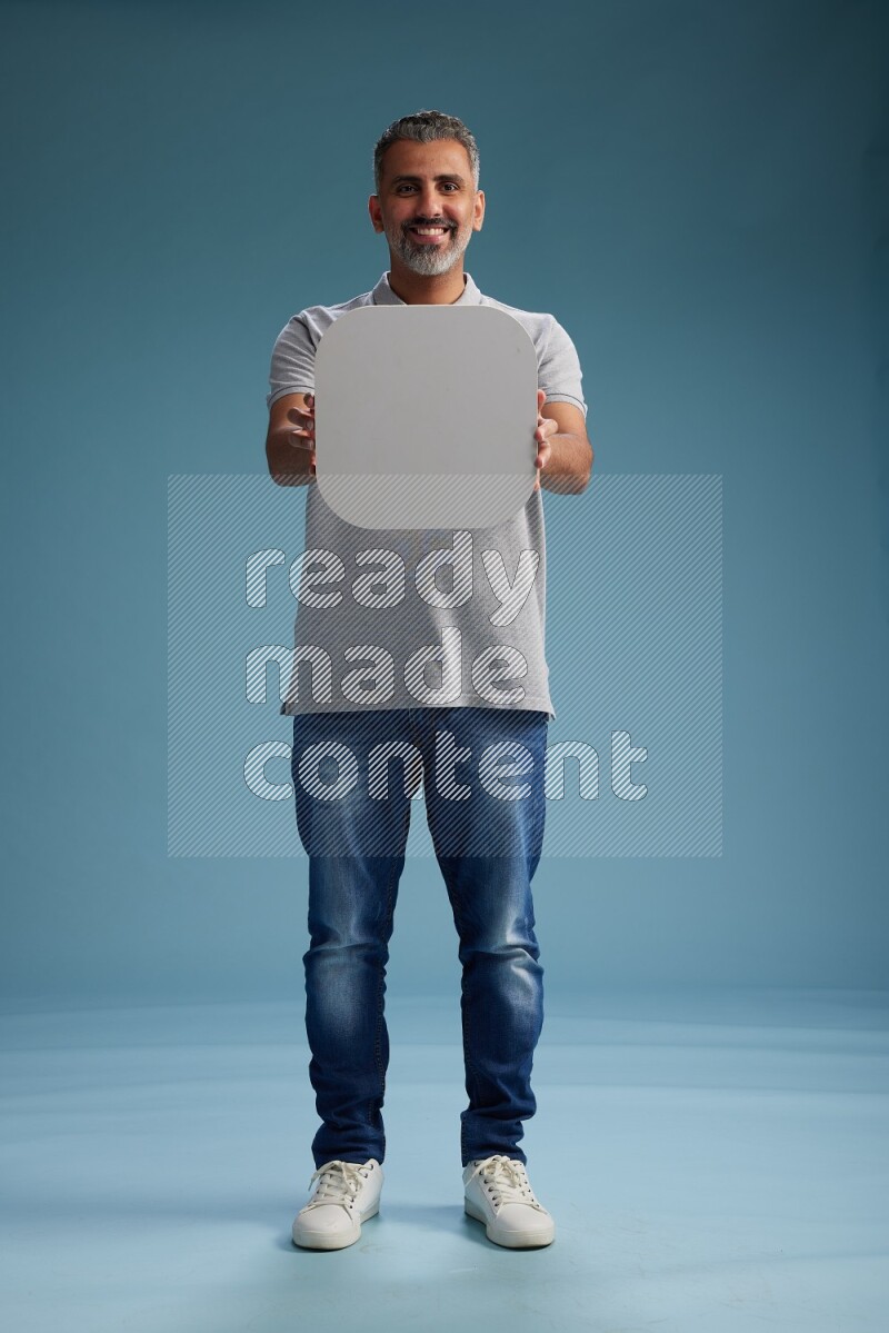 Man Standing holding social media sign on blue background