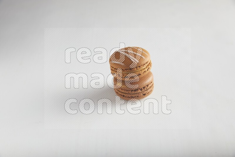 45º Shot of of two assorted Brown Irish Cream, and Brown Coffee macarons  on white background
