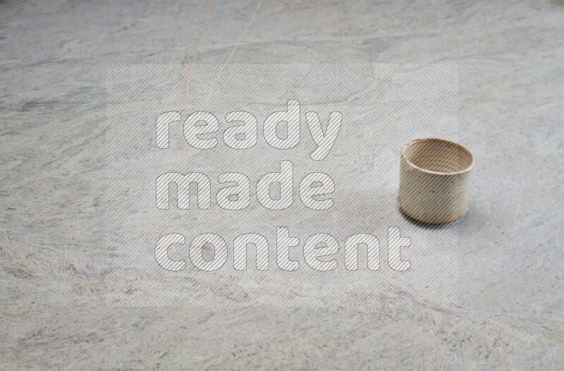 A multicolored pottery Cup on grey marble background