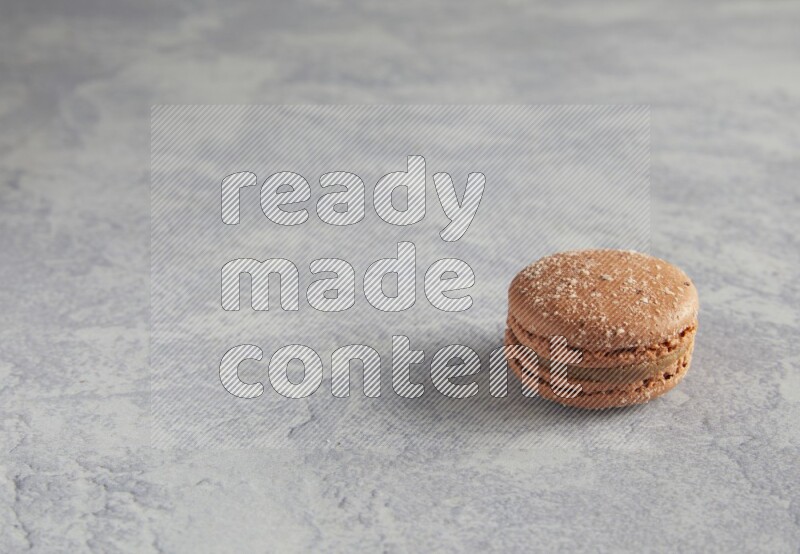 45º Shot of Brown Hazelnuts macaron on white  marble background