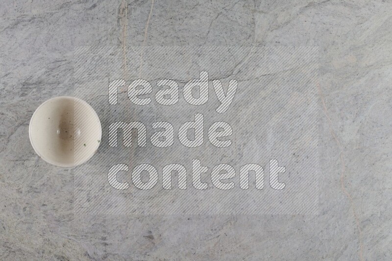A white pottery bowl on grey marble background