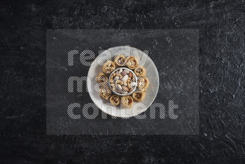 Konafa in a pottery plate in a dark setup