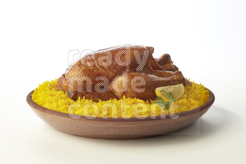 yellow basmati Rice with whole roasted chicken  on a pottery plate  direct  on white background