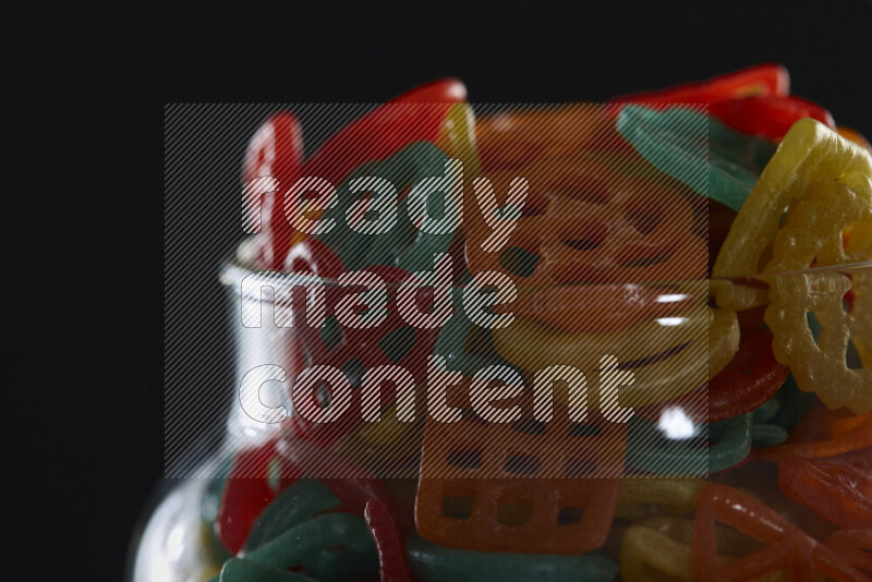 Snacks in a glass jar on black background