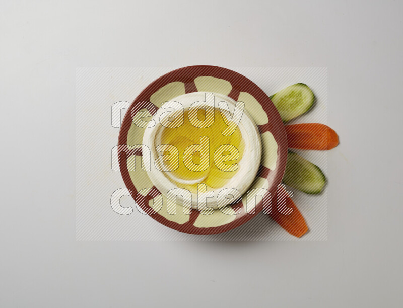 Lebnah garnished with olive oil in a traditional plate on a white background