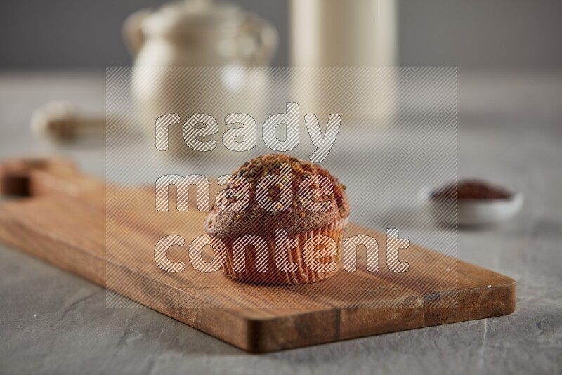 Pistachio cupcake on a wooden board