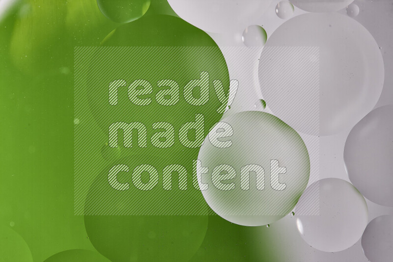 Close-ups of abstract oil bubbles on water surface in shades of white and green