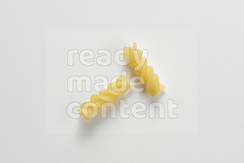 Fusilli pasta on white background